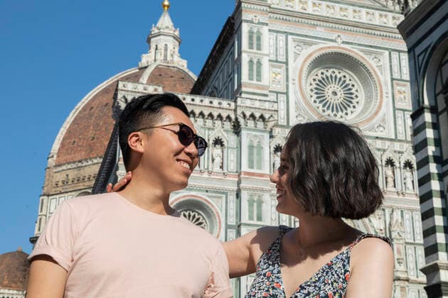 Mixed ethnicity couple smiling in front of the Duomo in Florence Italy Florence, Tuscany, Italy ,model released, Symbolfoto CR_CWLK200213B-309662-01