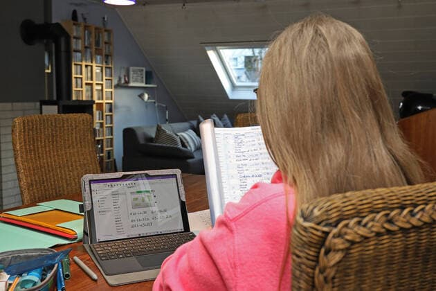 Fear of the coronavirus, schools are closed, a teenager sits at home in the living room with a tablet and school documents Symbol picture on the topic of coronavirus and school on 16 03 2020 in Siegen Germany