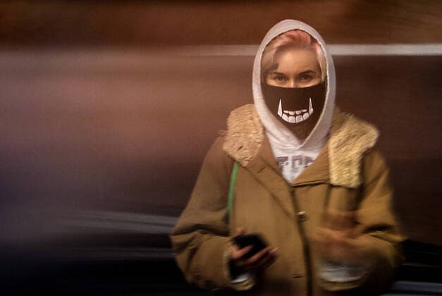 MOSCOW, RUSSIA - MARCH 16, 2020: A young woman in a face mask on the Moscow Underground (Moscow Metro). As of 16 March 2020, Russia has confirmed more than 90 cases of the novel coronavirus (COVID-19), with more than 50 cases in Moscow. The Russian government has announced plans to temporarily close Russia s borders to foreign travellers. Valery Sharifulin TASS  TS0D254A
