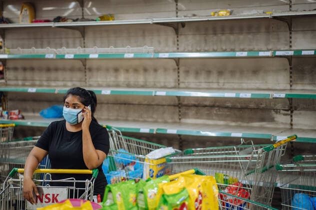 (200317) -- KUALA LUMPUR, March 17, 2020 -- A woman stands near empty shelves at a supermarket in Kuala Lumpur, Malaysia, early March 17, 2020. Malaysia is introducing comprehensive restrictive measures including closing shops and schools and imposing travel bans, in an effort to contain the COVID-19 outbreak, Prime Minister Muhyiddin Yassin announced Monday. ) MALAYSIA-KUALA LUMPUR-COVID-19-MEASURES ZhuxWei 
