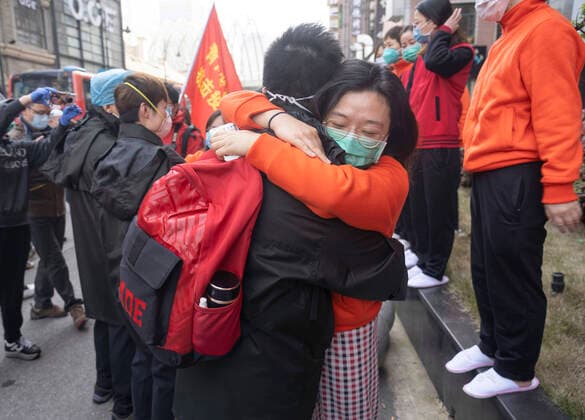 (200317) -- WUHAN, March 17, 2020 -- A medic from east China s Jiangxi Province (R) hugs a coworker from northwest China s Qinghai Province in Wuhan, central China s Hubei Province, on March 17, 2020. They worked together on combatting the COVID-19 at the same temporary hospital. The first batch of medics have been scheduled to depart Hubei, once the hard-hit province of the novel coronavirus, on Tuesday, as the epidemic situation has been greatly eased. The 3,675 medical staffers belonging to 41 medical teams from across China have assisted 14 temporary hospitals and seven designated hospitals in Wuhan, the provincial capital and epicenter of the outbreak. ) CHINA-WUHAN-COVID-19-MEDICS-DEPARTURE-FAREWELL (CN) CaixYang