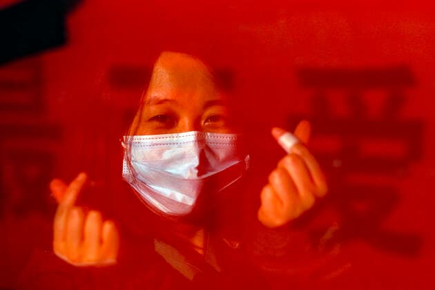 (200317) -- WUHAN, March 17, 2020 -- A medical staff from the First Affiliated Hospital of University of South China gestures on the train at a railway station in Wuhan, central China s Hubei Province, March 17, 2020. Some medical assistance teams started leaving Hubei Province on Tuesday as the epidemic outbreak in the hard-hit province has been subdued. ) CHINA-WUHAN-COVID-19-MEDICS-DEPARTURE (CN) ShenxBohan 
