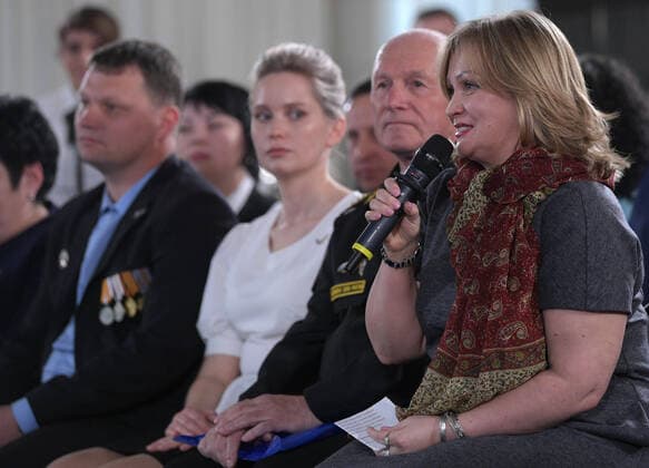 SEVASTOPOL, RUSSIA - MARCH 18, 2020: A woman asks a question during a public meeting with Russia s President Vladimir Putin at the Konstantinovskaya Batareya Konstantin Battery Museum and Exhibition Centre. Alexei Druzhinin Russian Presidential Press and Information Office TASS  TS0D2A44