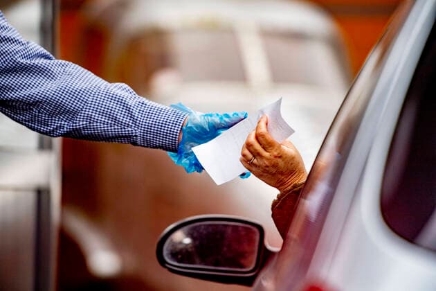 March 18, 2020, Schiphol, Netherlands: An employee wearing gloves as a protection seen giving the receipe to a costumer at a McDonald s Mac Drive amid Coronavirus (Covid-19) fear..Netherlands™s Health Ministry recorded a total of 2,460 infections, 76 death and 2 recovered since the beginning of the outbreak. Schiphol Netherlands - ZUMAs197 20200318_zaa_s197_237 Copyright: xRobinxUtrechtx