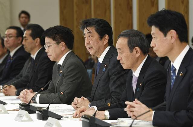 New coronavirus Japanese Prime Minister Shinzo Abe (C) speaks during a meeting on the coronavirus crisis on March 20, 2020, in Tokyo. 