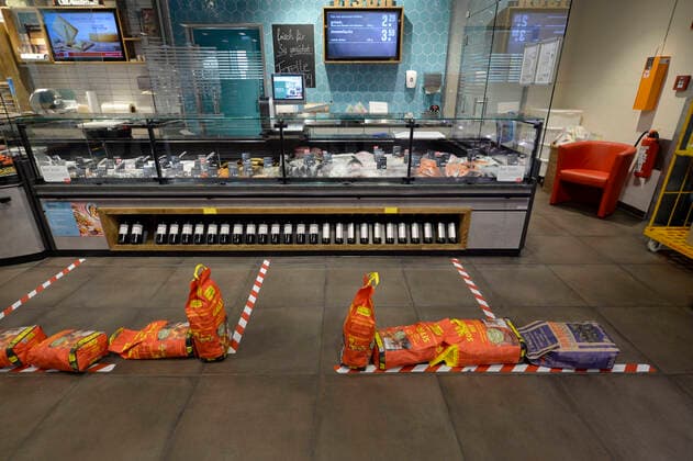 Avoidance of social contacts at the fish counter, cheese counter, sausage counter in the supermarket by means of several packs of barbecue charcoal and barrier tape due to corona virus, Covid 19, SARS CoV 2, Stuttgart, Baden Württemberg, Germany Empty pasta shelf in the supermarket, Stuttgart, Baden Württemberg, Germany