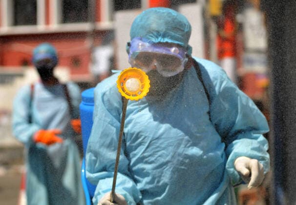 (200320) -- JAMMU, March 20, 2020 -- Health workers disinfect a closed market after authorities ordered the closure of all shops except pharmacies and grocery stores in Jammu, Indian-controlled Kashmir, March 20, 2020. (Str Xinhua) KASHMIR-JAMMU-COVID-19 Stringer 