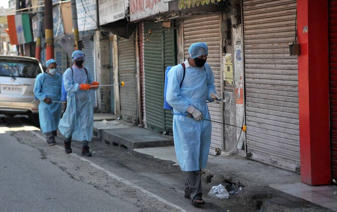 (200320) -- JAMMU, March 20, 2020 -- Health workers disinfect a closed market after authorities ordered the closure of all shops except pharmacies and grocery stores in Jammu, Indian-controlled Kashmir, March 20, 2020. (Str Xinhua) KASHMIR-JAMMU-COVID-19 Stringer 