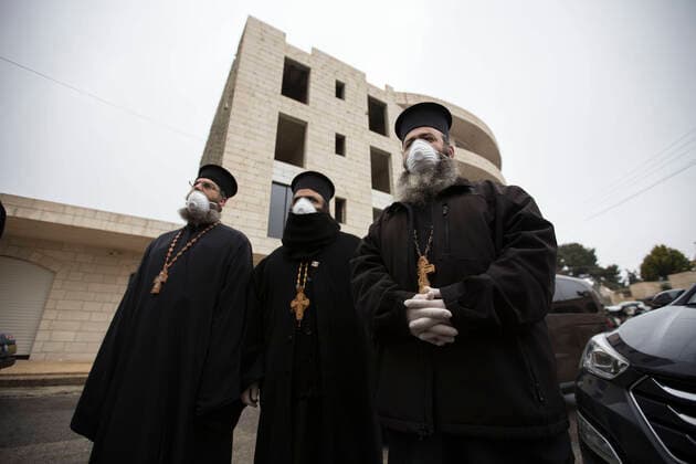 March 20, 2020, Beit Jala, West Bank: Christian piests watching the release of quarantined Palestinians from Angles Hotel, at end of the quarantine after 14 days. Beit Jala West Bank - ZUMAb133 20200320_zap_b133_014 Copyright: xMustafaxBaderx