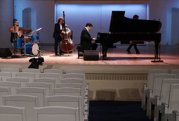 MOSCOW, RUSSIA - MARCH 20, 2020: Pianist Denis Matsuev, double bassist Andrei Ivanov and percussion player Alexander Zinger (R-L) perform during a live broadcast from the empty Tchaikovsky Concert Hall. The Russian Culture Ministry advised to suspend public events due to the COVID-19 coronavirus pandemic. Valery Sharifulin TASS  TS0D2E99