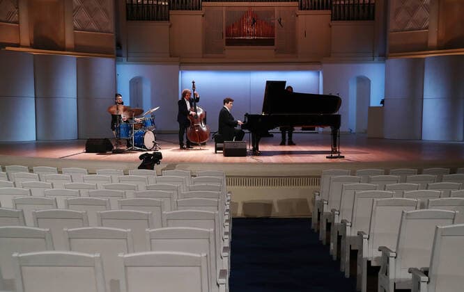 MOSCOW, RUSSIA - MARCH 20, 2020: Pianist Denis Matsuev, double bassist Andrei Ivanov and percussion player Alexander Zinger (R-L) perform during a live broadcast from the empty Tchaikovsky Concert Hall. The Russian Culture Ministry advised to suspend public events due to the COVID-19 coronavirus pandemic. Valery Sharifulin TASS  TS0D2E9C