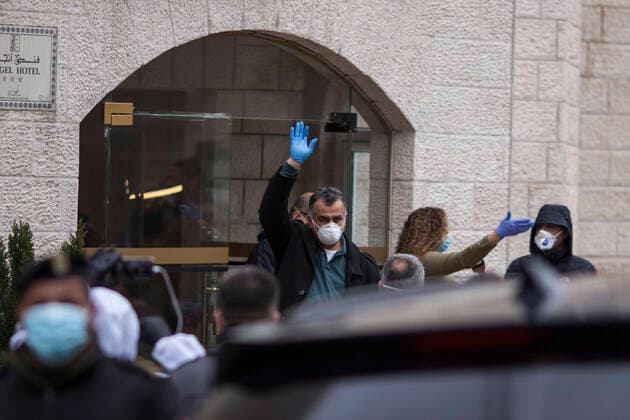 March 20, 2020, Beit Jala, West Bank: Palestinian doctor who s been with quarantined Palestinians at Angles Hotel salutes journalists & security forces, at the end of quarantine in the hotel after 14 days. Beit Jala West Bank - ZUMAb133 20200320_zap_b133_032 Copyright: xMustafaxBaderx