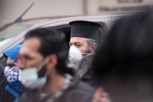 March 20, 2020, Beit Jala, West Bank: Christian piest watching the release of quarantined Palestinians from Angles Hotel, at end of the quarantine after 14 days. Beit Jala West Bank - ZUMAb133 20200320_zap_b133_033 Copyright: xMustafaxBaderx