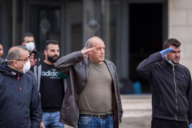 March 20, 2020, Bethlehem, West Bank: Released Palestinians from quarantine at Paradise Hotel salutes the medical staff & policemen after the end of 14 days quarantine. Bethlehem West Bank - ZUMAb133 20200320_zap_b133_048 Copyright: xMustafaxBaderx