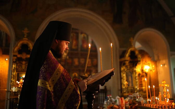 MOSCOW, RUSSIA - MARCH 20, 2020: A priest during an evening service at the Vysokopetrovsky Monastery. Starting from March 18 monks conduct a religious procession and spray holy water after the evening service at the monastery amid the coronavirus pandemic. Sergei Bobylev TASS  TS0D2ED8