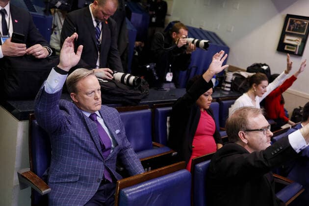 Sean Spicer, former White House press secretary, left, raises his hand to ask a question during a Coronavirus Task Force news conference in the briefing room of the White House in Washington, DC on Friday, March 20, 2020. Americans will have to practice social distancing for at least several more weeks to mitigate U.S. cases of Covid-19, Anthony S. Fauci of the National Institutes of Health said today.  WAX20200320925 ALxDRAGO
