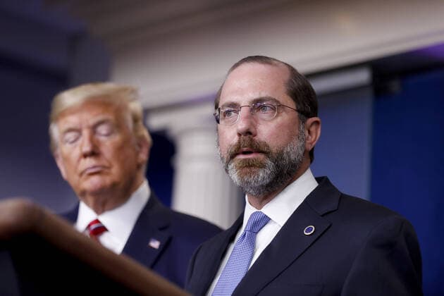 Alex Azar, secretary of Health and Human Services (HHS), speaks as U.S. President Donald Trump, left, listens during a Coronavirus Task Force news conference in the briefing room of the White House in Washington, DC on Friday, March 20, 2020. Americans will have to practice social distancing for at least several more weeks to mitigate U.S. cases of Covid-19, Anthony S. Fauci of the National Institutes of Health said today.  WAX20200320937 ALxDRAGO