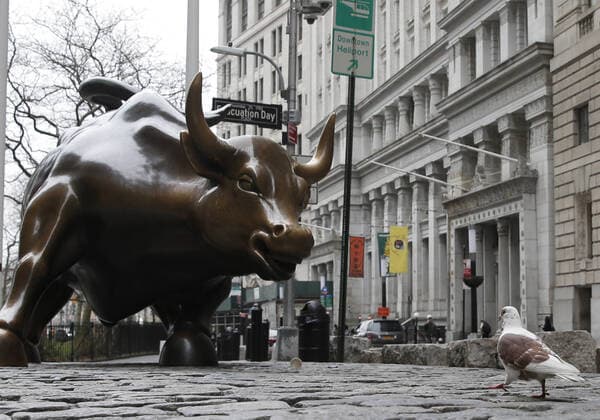 Almost no pedestrian traffic surrounds the Wall Street Statue of the Charging Bull on Broadway just north of Bowling Green after the opening bell on Wall Street in New York City on Friday, March 20, 2020. The New York Stock Exchange will close down the floor and will move temporarily to fully electronic trading on Monday, March 23 due to the Coronavirus pandemic.  NYP20200320157 JOHNxANGELILLO