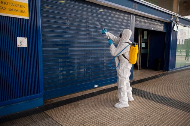 March 20, 2020, Pamplona, Navarra, Spain: Member of the Military Emergency Unit disinfecting the shutter of the Immigration Office located in Pamplona..A total of four self-bomb trucks and 15 military personnel wearing protective equipment continue the disinfection work entrusted to the Spanish Military Emergency Unit by the Ministry of Interior, in areas that could have been infected with the coronavirus Pamplona Spain - ZUMAs197 20200320_zaa_s197_106 Copyright: xElsaxAxBravox