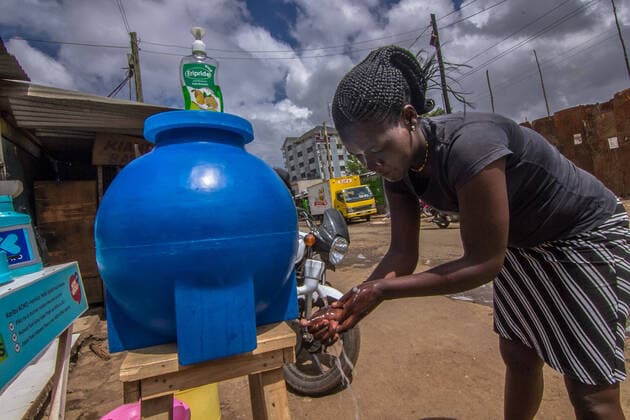 March 20, 2020, Nairobi, Kenya, Africa: A woman is seen washing her hand at a public handwashing station set up in Kibera slums. Nairobi Africa - ZUMAd156 20200320_zip_d156_006 Copyright: xDonwilsonxOdhiambox