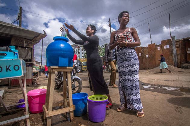 March 20, 2020, Nairobi, Kenya, Africa: Young Women are seen washing their hands at a local public handwashing station set up in Kibera slums. Nairobi Africa - ZUMAd156 20200320_zip_d156_007 Copyright: xDonwilsonxOdhiambox
