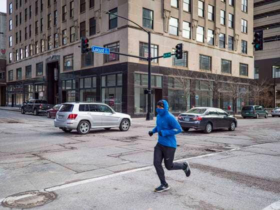 March 20, 2020, Des Moines, Iowa, U.S: A jogger runs through the deserted streets of Des Moines. Most of downtown Des Moines is empty as businesses move to work at home and more businesses have employees who test positive for COVID-19. On Friday morning, 20 March, Iowa reported 45 confirmed cases of the Coronavirus. Restaurants, bars, movie theaters, places that draw crowds are closed for at least 30 days. There are no shelter in place orders in effect anywhere in Iowa but people are being encouraged to practice social distancing and many businesses are requiring or encouraging employees to telecommute. Des Moines U.S. - ZUMAk94_ 20200320_zaf_k94_009 Copyright: xJackxKurtzx
