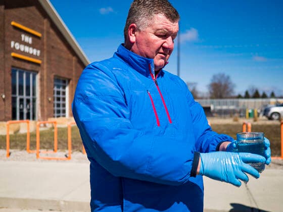 March 20, 2020, Des Moines, Iowa, U.S: CHAD BUSH carries hand sanitizer to a waiting car at the Foundry, a distillery in Des Moines. The distillery suspended its distilling operations to make hand sanitizer this week. They distributed it free to people who came to their building. On Friday thousands of people came to get some. There line was more than one mile long. On Friday morning, 20 March, Iowa reported 45 confirmed cases of the Coronavirus. Restaurants, bars, movie theaters, places that draw crowds are closed for at least 30 days. There are no shelter in place orders in effect anywhere in Iowa but people are being encouraged to practice social distancing and many businesses are requiring or encouraging employees to telecommute. Des Moines U.S. - ZUMAk94_ 20200320_zaf_k94_013 Copyright: xJackxKurtzx