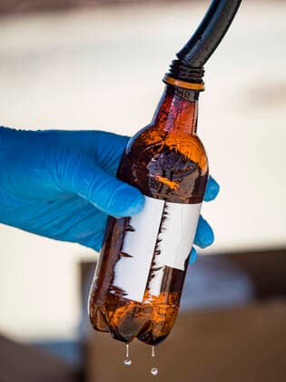 March 20, 2020, Des Moines, Iowa, U.S: Workers at the Foundry, a distillery in Des Moines, pour hand sanitizer into a used root beer bottle for a waiting motorist. The distillery suspended its distilling operations to make hand sanitizer this week. They distributed it free to people who came to their building. On Friday thousands of people came to get some. There line was more than one mile long. On Friday morning, 20 March, Iowa reported 45 confirmed cases of the Coronavirus. Restaurants, bars, movie theaters, places that draw crowds are closed for at least 30 days. There are no shelter in place orders in effect anywhere in Iowa but people are being encouraged to practice social distancing and many businesses are requiring or encouraging employees to telecommute. Des Moines U.S. - ZUMAk94_ 20200320_zaf_k94_020 Copyright: xJackxKurtzx