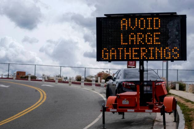 March 20, 2020, Los Angeles, California, U.S: A sign urging people to avoid the COVID-19 is displayed near the Hollywood Sign on Friday, March 20, 2020, in Los Angeles. California Gov. Gavin Newsom issued a statewide stay-at-home order Thursday for residents to venture outside only for essential jobs, errands and some exercise, due to coronavirus concerns. Los Angeles U.S. - ZUMAc68_ 20200320_zaf_c68_005 Copyright: xRingoxChiux