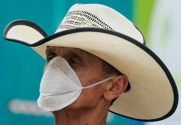 March 20, 2020, Los Angeles, California, U.S: A man wearing a face mask is seen near the historic street, Olvera Street on Friday, March 20, 2020, in Los Angeles. California Gov. Gavin Newsom issued a statewide stay-at-home order Thursday for residents to venture outside only for essential jobs, errands and some exercise, due to coronavirus concerns. Los Angeles U.S. - ZUMAc68_ 20200320_zaf_c68_014 Copyright: xRingoxChiux