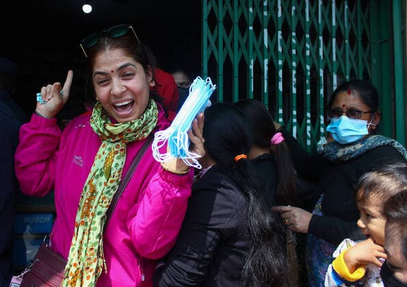 Impact of COVID-19 at Kathmandu A Nepalese woman being happy after getting a face mask at the Sajha Shwashthya Sewa drug store run by the Government of Nepal in Kathmandu, Nepal on Friday, March 20, 2020. Government selling masks which were seized from different places by Nepal Police during the Corona virus (COVID-19) outbreak. Kathmandu Bagmati Nepal Copyright: SubashxShrestha