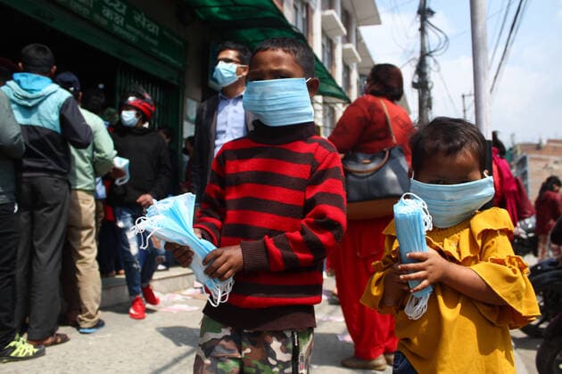 Impact of COVID-19 at Kathmandu Children buys a face mask from Sajha Shwashthya Sewa drug store run by the Government of Nepal in Kathmandu, Nepal on Friday, March 20, 2020. Government selling masks which were seized from different places by Nepal Police during the Corona virus (COVID-19) outbreak. Kathmandu Bagmati Nepal Copyright: SubashxShrestha