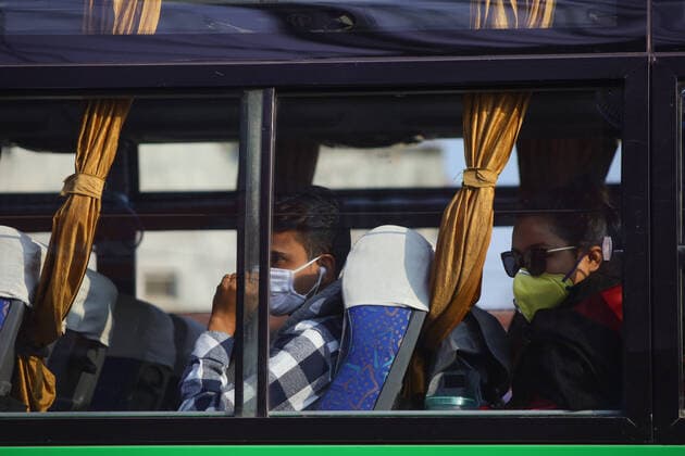 Impact of COVID-19 at Kathmandu Passengers wear masks sits inside bus to leave kathmandu amid concerns of Coronavirus (COVID-19) in Kathmandu, Nepal on Friday, March 20, 2020. Kathmandu Bagmati Nepal Copyright: SubashxShrestha