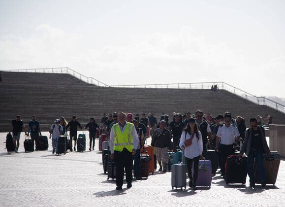 CORONAVIRUS AUSTRALIA, Crew members of the Cruise Ship Ovation of the Seas walking past the Sydney Opera House after disembarking from the ship, Sydney, Saturday, March 21, 2020. Sydney is seeing a dramatic reduction in people on the streets as people are asked to enact social distancing and self isolation in order to prevent the spread of Covid-19. ( NO ARCHIVING, EDITORIAL USE ONLY, NO USE IN BOOKS WITHOUT CONSENT SYDNEY NSW AUSTRALIA  Copyright: xJAMESxGOURLEYx 20200321001458535743