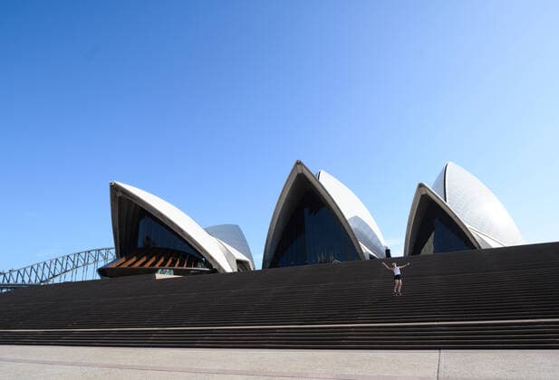 CORONAVIRUS AUSTRALIA, A lone tourist jumps on the steps of the Sydney Opera House, Sydney, Saturday, March 21, 2020. Sydney is seeing a dramatic reduction in people on the streets as people are asked to enact social distancing and self isolation in order to prevent the spread of Covid-19. ( NO ARCHIVING, EDITORIAL USE ONLY, NO USE IN BOOKS WITHOUT CONSENT SYDNEY NSW AUSTRALIA  Copyright: xJAMESxGOURLEYx 20200321001458535964