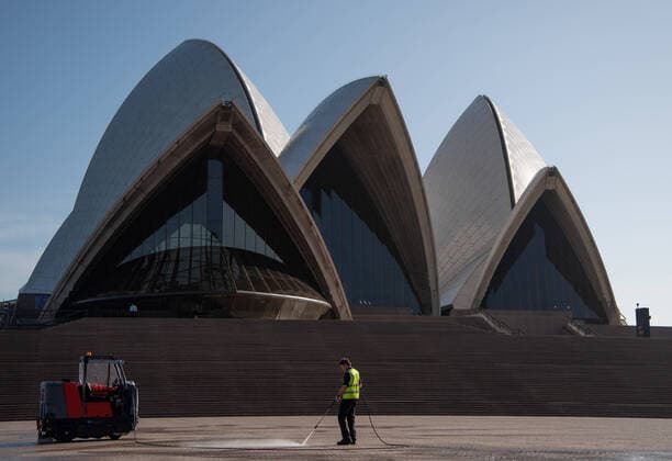 CORONAVIRUS AUSTRALIA, A worker cleaning in front of a nearly deserted Sydney Opera House, Sydney, Saturday, March 21, 2020. Sydney is seeing a dramatic reduction in people on the streets as people are asked to enact social distancing and self isolation in order to prevent the spread of Covid-19. ( NO ARCHIVING, EDITORIAL USE ONLY, NO USE IN BOOKS WITHOUT CONSENT SYDNEY NSW AUSTRALIA  Copyright: xJAMESxGOURLEYx 20200321001458535984