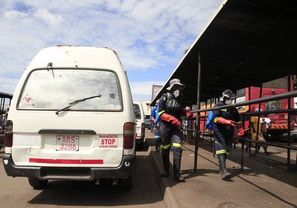(200321) -- HARARE, March 21, 2020 (Xinhua) -- Health workers disinfect a public bus terminus in Harare, Zimbabwe, March 20, 2020. Zimbabwe on Friday reported its first confirmed case of COVID-19 after a male from Victoria Falls, who had traveled to the United Kingdom, was tested positive. (Photo by Shaun Jusa Xinhua) ZIMBABWE-HARARE-CORONAVIRUS-FIRST CASE 
