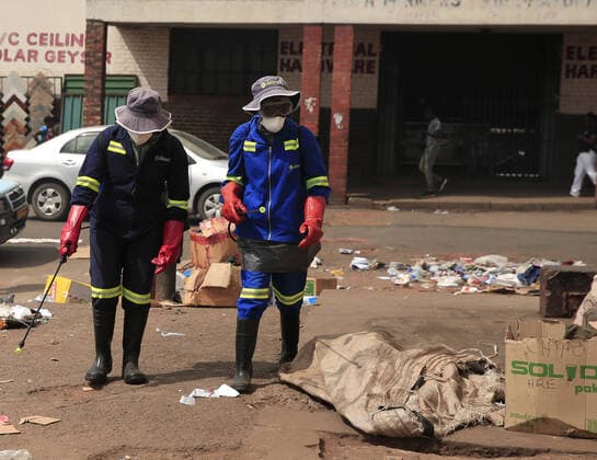 (200321) -- HARARE, March 21, 2020 (Xinhua) -- Health workers disinfect a public bus terminus in Harare, Zimbabwe, March 20, 2020. Zimbabwe on Friday reported its first confirmed case of COVID-19 after a male from Victoria Falls, who had traveled to the United Kingdom, was tested positive. (Photo by Shaun Jusa Xinhua) ZIMBABWE-HARARE-CORONAVIRUS-FIRST CASE 