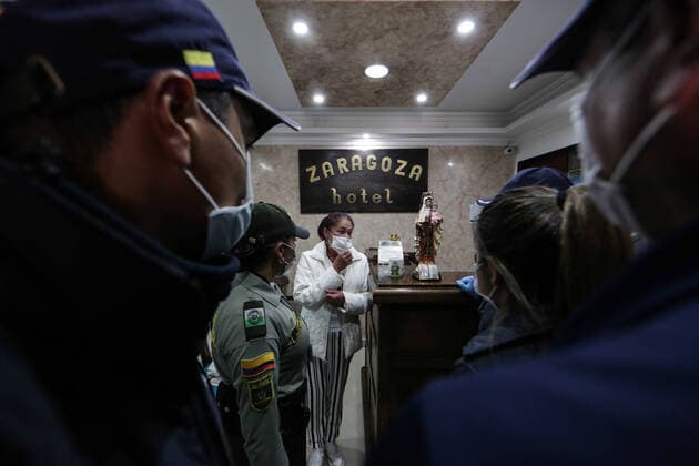 (200321) -- BOGOTA, March 21, 2020 (Xinhua) -- Personnel of immigration authorities check the epidemic prevention measures at a hotel in Bogota, Colombia, March 20, 2020. The Colombian capital of Bogota began on Friday the mandatory isolation drill decreed by mayor Claudia Lopez in order to prepare for a quarantine aimed at containing the COVID-19 pandemic. The mandatory isolation drill in the Colombian capital, home to more than seven million people and where 56 of Colombia s 145 cases of COVID-19 have been confirmed, will remain in effect until midnight on March 23. (Photo by Jhon Paz Xinhua) COLOMBIA-BOGOTA-MANDATORY ISOLATION 