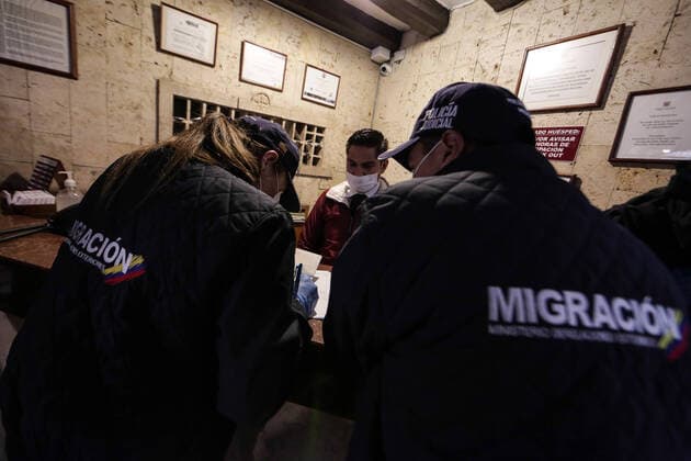 (200321) -- BOGOTA, March 21, 2020 (Xinhua) -- Personnel of immigration authorities check the epidemic prevention measures at a hotel in Bogota, Colombia, March 20, 2020. The Colombian capital of Bogota began on Friday the mandatory isolation drill decreed by mayor Claudia Lopez in order to prepare for a quarantine aimed at containing the COVID-19 pandemic. The mandatory isolation drill in the Colombian capital, home to more than seven million people and where 56 of Colombia s 145 cases of COVID-19 have been confirmed, will remain in effect until midnight on March 23. (Photo by Jhon Paz Xinhua) COLOMBIA-BOGOTA-MANDATORY ISOLATION 