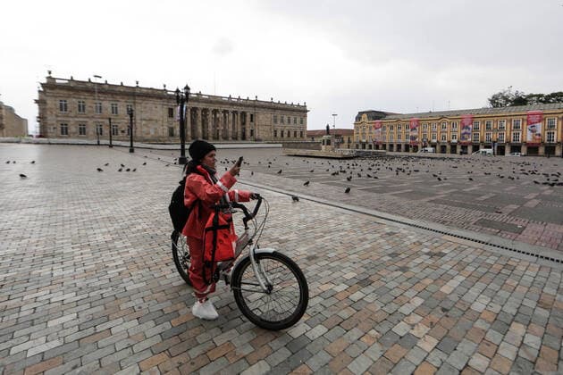 (200321) -- BOGOTA, March 21, 2020 (Xinhua) -- A deliverywoman is seen on the Bolivar Square in Bogota, Colombia, March 20, 2020. The Colombian capital of Bogota began on Friday the mandatory isolation drill decreed by mayor Claudia Lopez in order to prepare for a quarantine aimed at containing the COVID-19 pandemic. The mandatory isolation drill in the Colombian capital, home to more than seven million people and where 56 of Colombia s 145 cases of COVID-19 have been confirmed, will remain in effect until midnight on March 23. (Photo by Jhon Paz Xinhua) COLOMBIA-BOGOTA-MANDATORY ISOLATION 