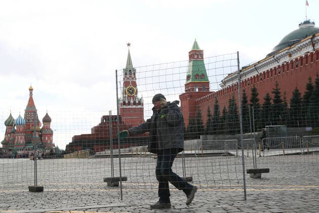 MOSCOW, RUSSIA - MARCH 21, 2020: A man moving a barrier in Red Square. Alexander Shcherbak TASS  TS0D2F0F