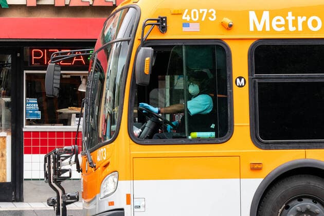 (200321) -- LOS ANGELES, March 21, 2020 -- A bus driver wearing a face mask is seen in Los Angeles, California, the United States, March 20, 2020. California Governor Gavin Newsom announced Thursday evening a statewide stay-at-home order for the most populous U.S. state in response to the rapid spread of COVID-19. The governor s order went into effect immediately and is in place until further notice. (Photo by Xinhua) U.S.-CALIFORNIA-COVID-19-STAY-AT-HOME ORDER QianxWeizhong 