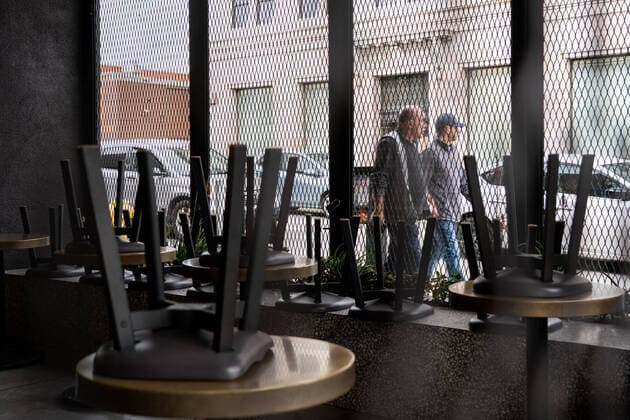 (200321) -- LOS ANGELES, March 21, 2020 -- People walk past a closed restaurant in Los Angeles, California, the United States, March 20, 2020. California Governor Gavin Newsom announced Thursday evening a statewide stay-at-home order for the most populous U.S. state in response to the rapid spread of COVID-19. The governor s order went into effect immediately and is in place until further notice. (Photo by Xinhua) U.S.-CALIFORNIA-COVID-19-STAY-AT-HOME ORDER QianxWeizhong 
