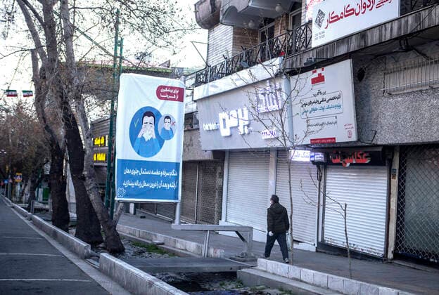 (200321) -- TEHRAN, March 21, 2020 -- A man walks past an empty street in Tehran, Iran, on March 20, 2020. The total number of confirmed COVID-19 cases in Iran edged toward 20,000 on Friday. (Photo by Xinhua) IRAN-TEHRAN-COVID-19-EMPTY STREETS AhmadxHalabisaz 