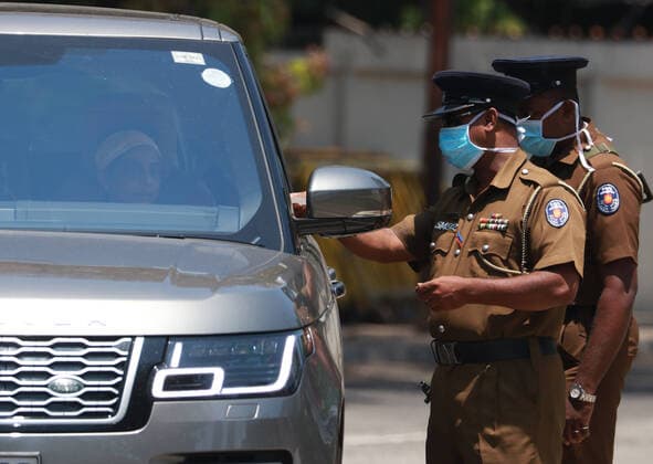 Sri Lanka: Empty street after curfew due to COVID-19 Police check a vehicle in the empty street is seen after the authorities announced a weekend curfew in the country as a preventive measure against the spread of the COVID-19 novel coronavirus, in Colombo March 21, 2020. Colombo Western Province Sri Lanka Copyright: SamanxAbesiriwardana