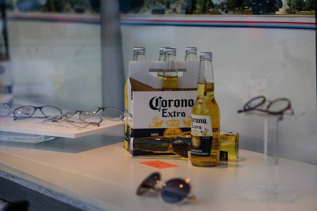 March 21, 2020: In a shop window of an optician in Berlin Schoeneberg several bottles of Corona beer can be seen next to the regular display. The Governing Mayor of Berlin, Michael Mueller (SPD), prepares restricting residents movements to contain the deadly coronavirus pandemic. Public venues such as bars, clubs, museums, cinemas, schools, daycare centers and universities have already closed. Many businesses are resorting to home office work for their employees. And travel across the border to most neighbouring countries is severely restricted. - ZUMAs172 20200321_zap_s172_030 Copyright: xJanxScheunertx