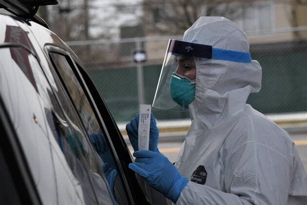 Staff Sergeant Meghann Cinnamond, a member of the New York Air National Guard s 109th Airlift Wing, in Scotia, New York, counsels a passenger regarding test sample collection at the drive-through COVID-19 Mobile Testing Center located at the South Beach Behavioral Center, Staten Island, NewYork on March 19, 2020. Members of the New York Army and Air National Guard have been activated under Operation COVID-19 to support, state, and local efforts.  WAX2020032106 Maj.xPatrickxCordova