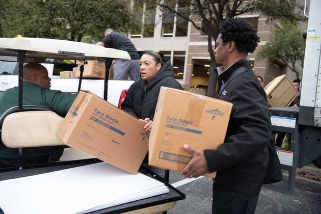 March 21, 2020, Dallas, Texas: Dallas County Parkland Hospital employees unload PPE equipment that will be used in the Dallas County COVID19 Testing Center, which opened on Saturday morning, on a parking lot near the American Airlines Center in downtown Dallas...The first of two county-sponsored testing centers will have enough kits to test nearly 5,000 persons per week...People seeking tests do not have to be Dallas County residents. However, in order to be tested, individuals must have a fever of 99.6 degrees or above and be either 65 or older, a first responder, a health care worker or a Dallas Area Rapid Transit bus driver. Dallas - ZUMAa183 20200321_znp_a183_002 Copyright: xAvixAdelmanx