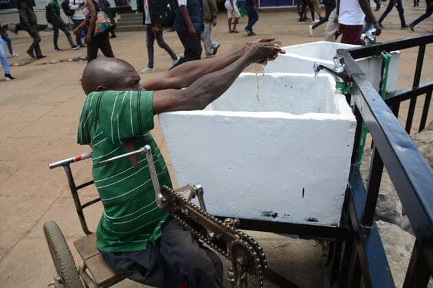 March 21, 2020, Nairobi, Kenya: A disabled man in a wheelchair is pictured washing his hands in a public water tap on the streets of Nairobi, Kenya as a preventive measure against the covid-19..The Kenyan government has banned all public gatherings activities, rallies and crusades. Places of worship are allowed to hold prayers provided they have hand sanitizers. Kenya has so far reported only seven cases of coronavirus. Nairobi Kenya - ZUMAs197 20200321_zaa_s197_080 Copyright: xDennisxSigwex